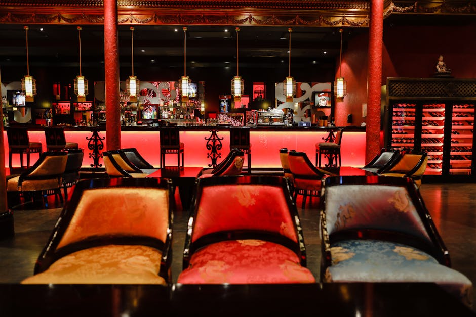 Exclusive VIP gaming room with elegant decor, private gaming tables and pink ambient lighting